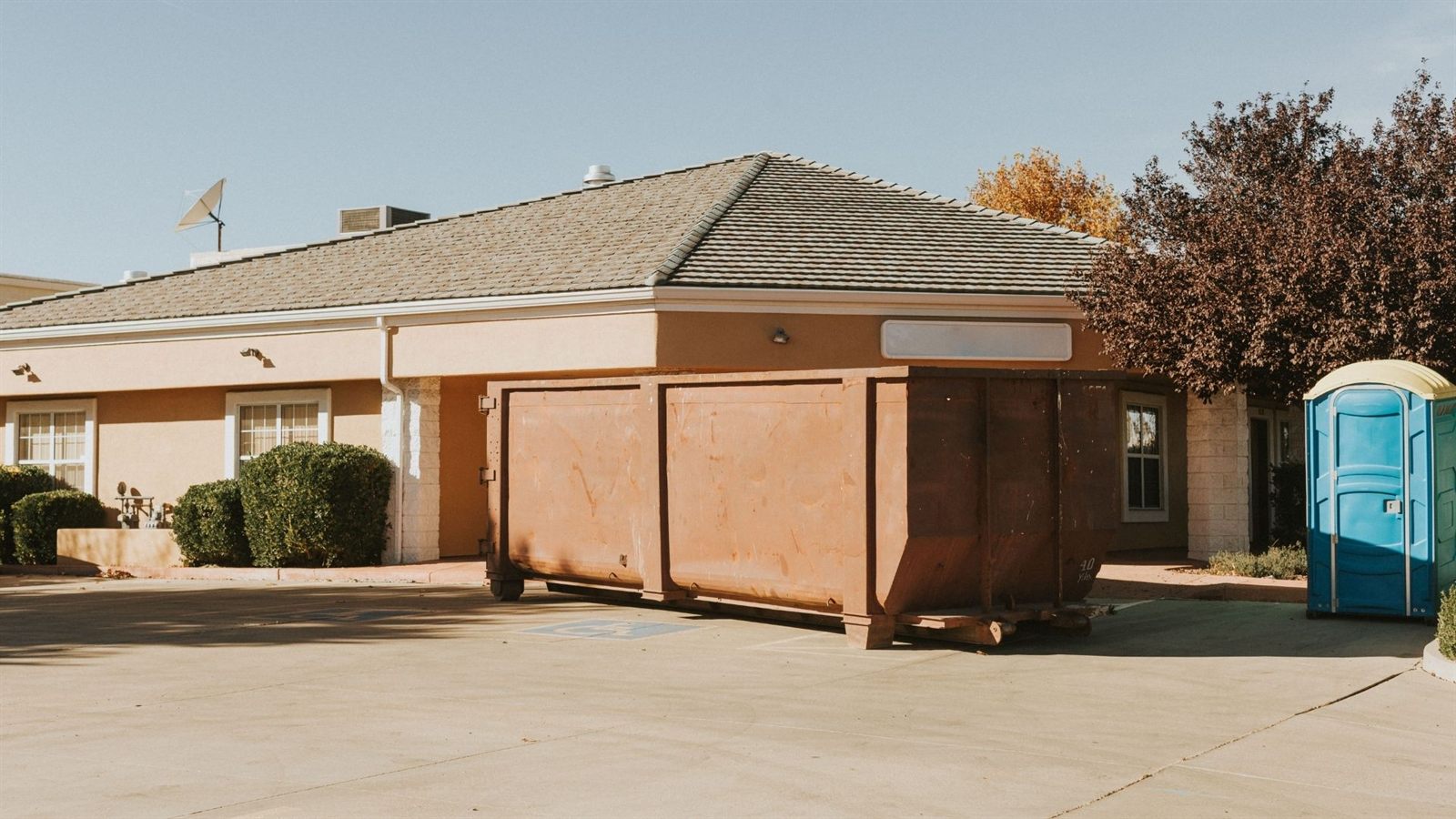 Blue dumpster in residential construction area