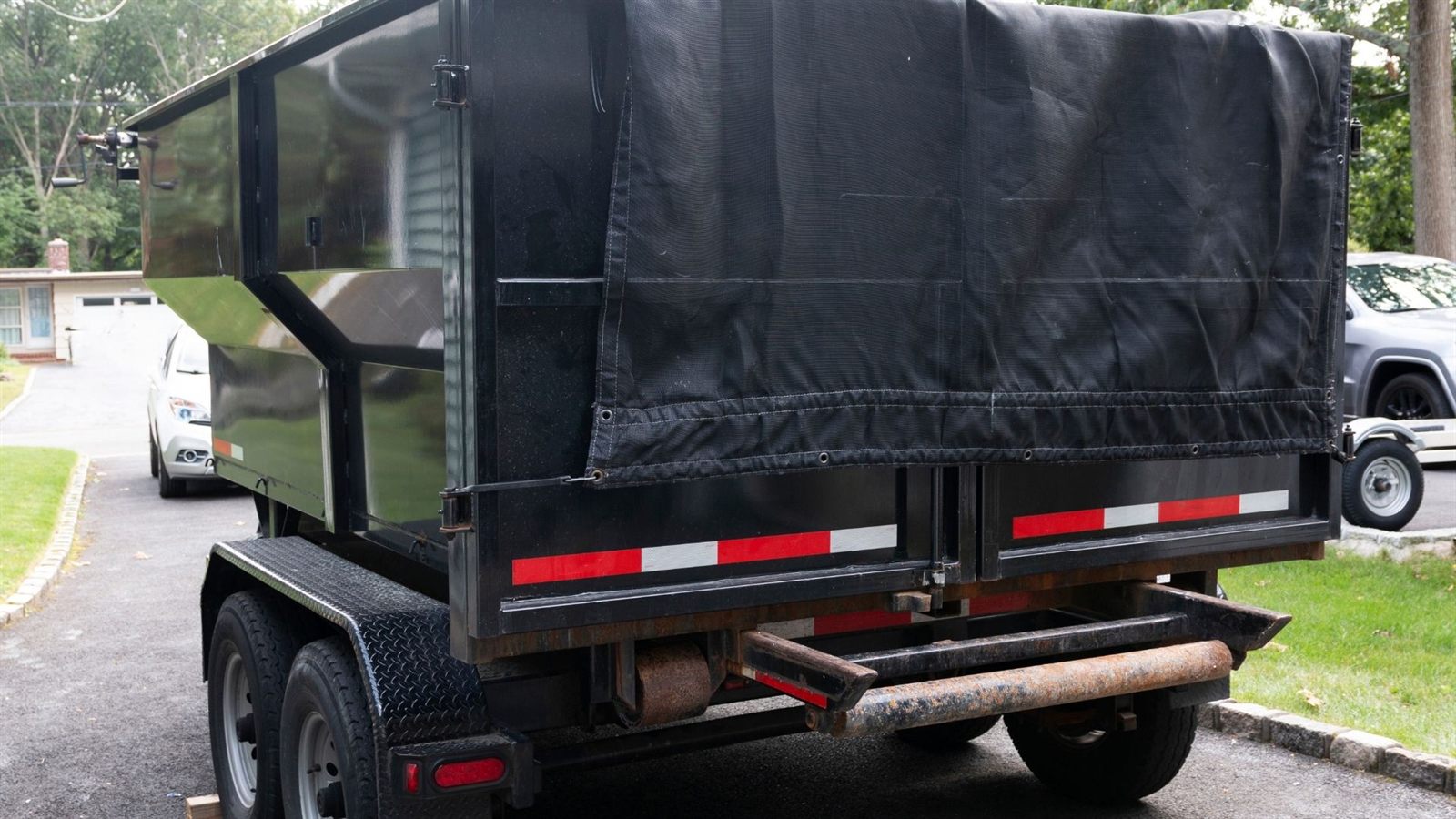 Residential roll off dumpster by a home