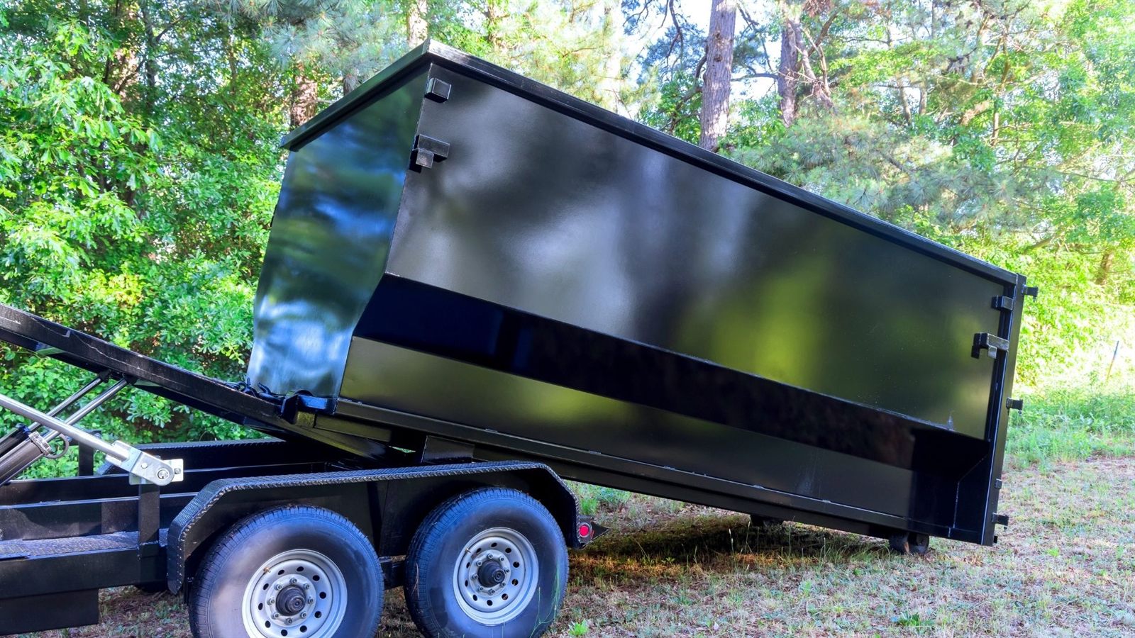 Black residential dumpster ready for cleanout work